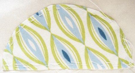 Image of blue and green printed fabric in a modern motif.